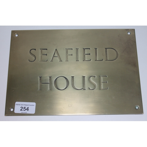 254 - A brass house name plate 'Seafield House', 25.5cm x 17.5cm.