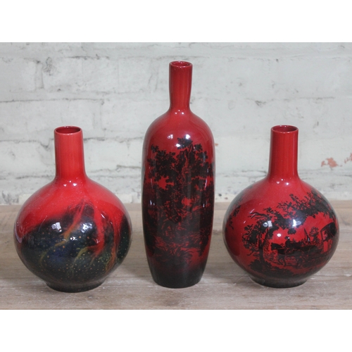 276 - A group of three Royal Doulton flambe vases, tallest 35cm.