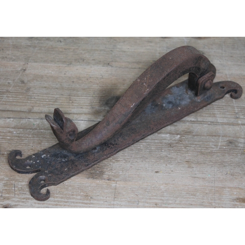 288 - A wrought metal door knocker formed as a ducks head, length 32.5cm.