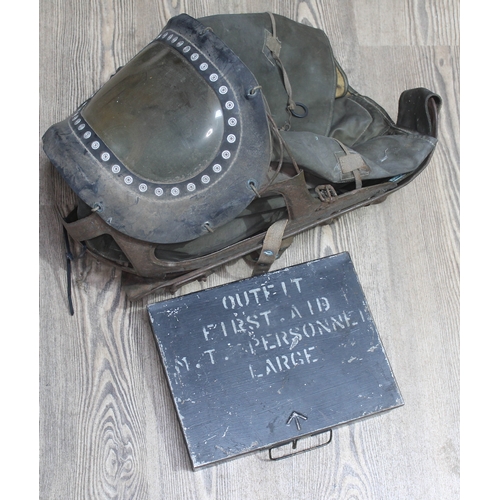 293 - A WWII child's gas mask and first aid kit.