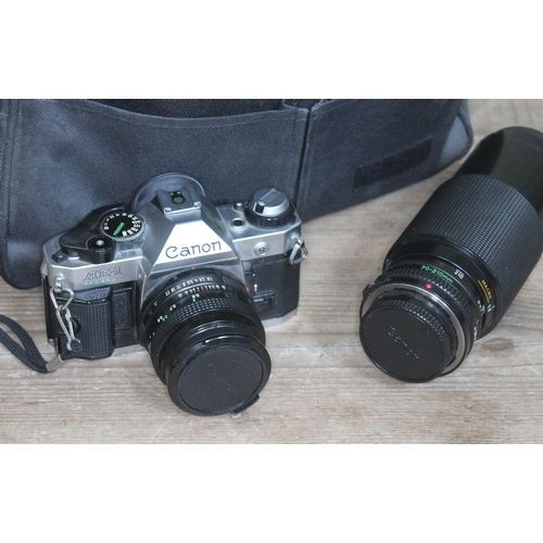 298 - A Canon AE-1 Program camera with f1.8 lens, Canon 70-210 f4 zoom lens, various filters, flash unit, ... 