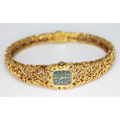 101 - A 1967 ladies hallmarked 18ct gold Omega bracelet watch, reference 8180, with green signed dial, hou... 