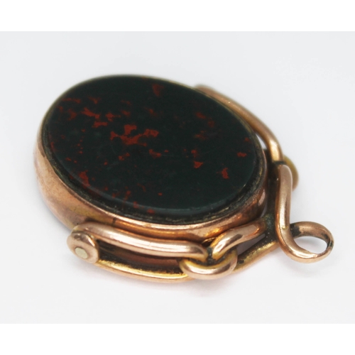 163 - A hallmarked 9ct gold swivel fob set with bloodstone and carnelian, length 28mm, gross wt. 6.46g.