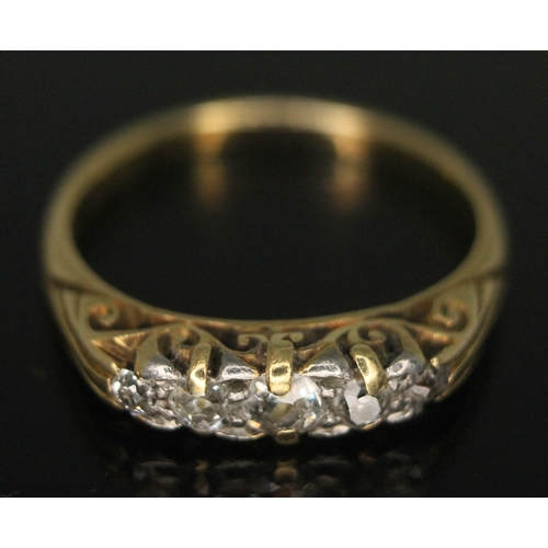 169 - A five stone diamond ring, the old European cut diamonds in scroll work setting and weighing approx.... 