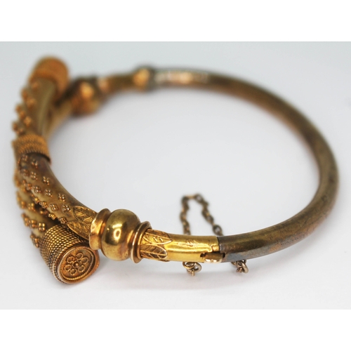 172 - A Victorian Aesthetic bangle, diam. approx. 5.5cm, marked '15ct', wt. 16.54g.