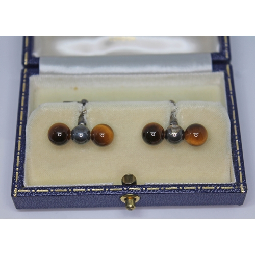 177 - A pair of Mappin & Webb silver cufflinks, each set with a pair of quartz tiger's eye beads, London 1... 