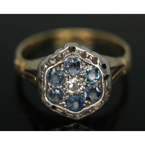 242 - An early 20th century flower head cluster ring set with pale blue and colourless stones, head diam. ... 