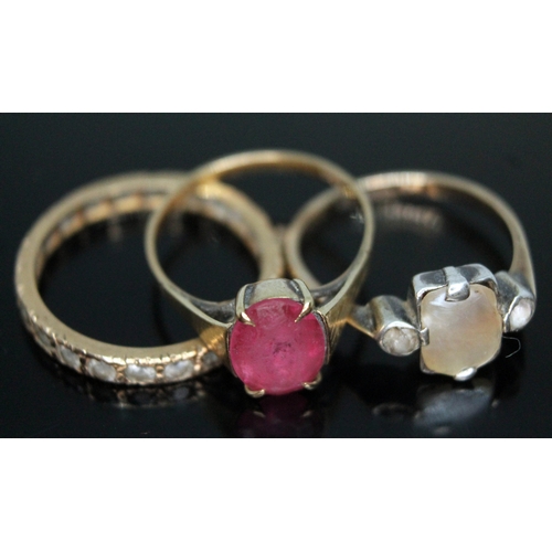 253 - A group of three rings comprising an eternity band unmarked, a ring set with pink paste marked '9ct'... 