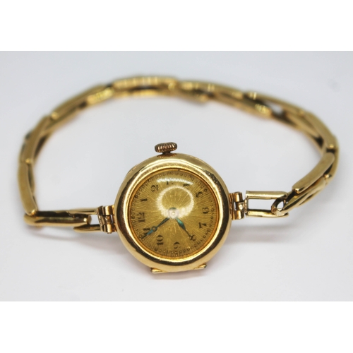 256 - A ladie's hallmarked 18ct gold wristwatch with strap marked '18ct', gross wt. 13.29g.