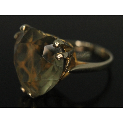 281 - A heart shaped citrine ring set in open work setting with heart cut outs, band marked '9ct', the sto... 