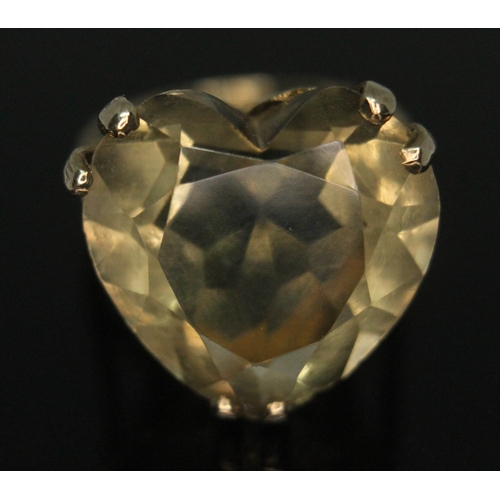 281 - A heart shaped citrine ring set in open work setting with heart cut outs, band marked '9ct', the sto... 