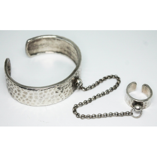 285 - A vintage hammered pewter bangle and ring with linked chain by Scooter Paris, numbered '52' and mark... 