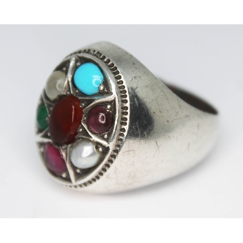 291 - A contemporary multi gemstone ring set with a central amber cabochon and surround by moonstone, turq... 