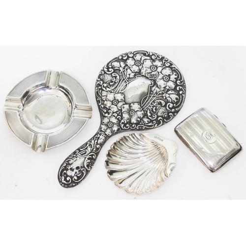 331 - A mixed lot of hallmarked silver comprising a hand mirror, an ash tray, a half clam dish and a cigar... 