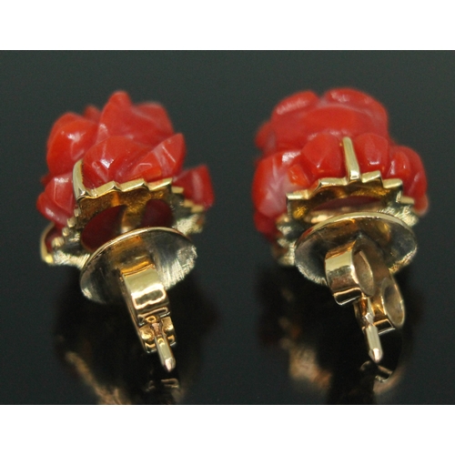 368 - A pair of carved coral ear studs, marked '18K', length 2mm, gross wt. 4.91g, with box stamped 'Fat C... 