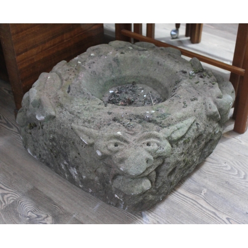 61 - An antique carved sandstone water feature with spouting gargoyles, approx. 50cm x 50cm.