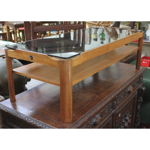 63 - A retro teak coffee table by Myer with smoked glass top, length 112cm.