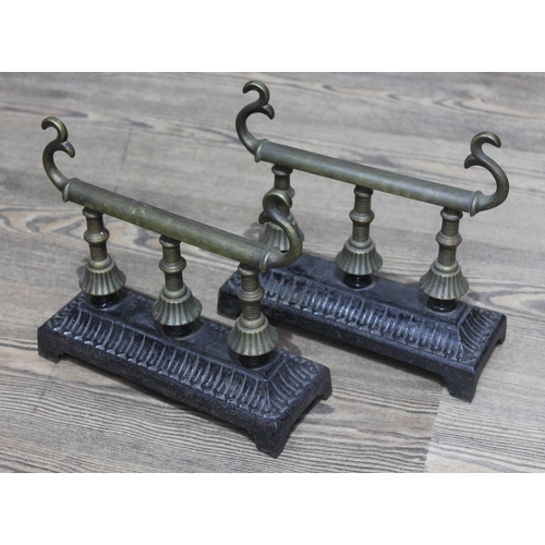 74 - A Victorian cast iron fender, length 146cm, together with a pair of Dresseresque fire dogs.