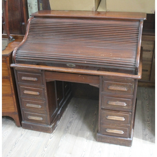 76 - A roll top pedestal desk, width 121cm, depth 84cm & height 115cm.