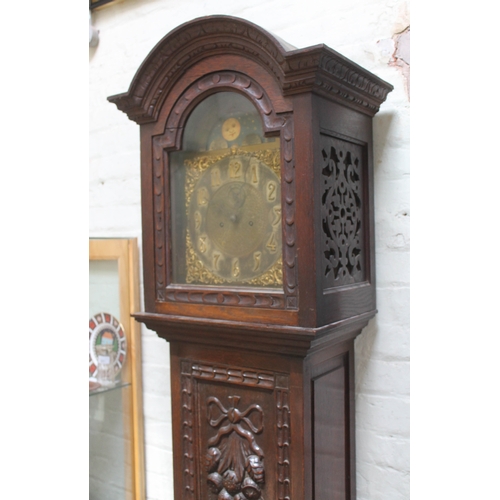 81 - A late Victorian oak long case clock with domed hood, brass and silvered dial with gothic numerals a... 