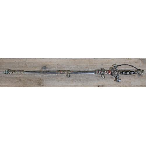 396 - A Knights of Pythias ceremonial sword and scabbard, the guard monogrammed 'FCB', the etched blade in... 