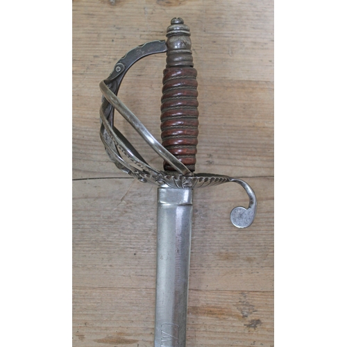 405 - A reproduction sword, the blade stamped 'Carlos III' and 'Dragones Toledo 1740', blade length 80cm.