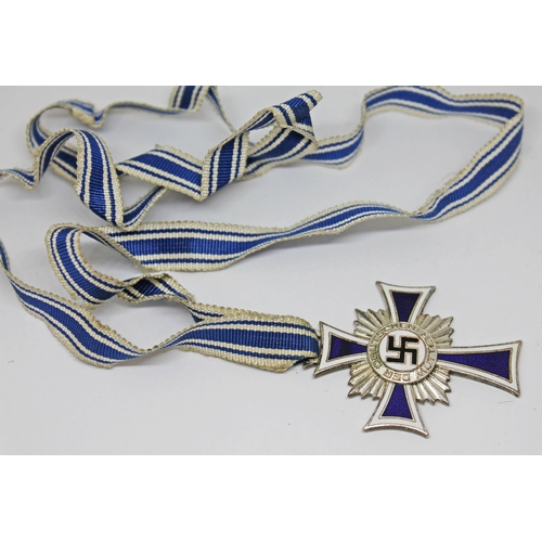 461 - A German WWII Cross of Honour of the German Mother with blue and white ribbon.