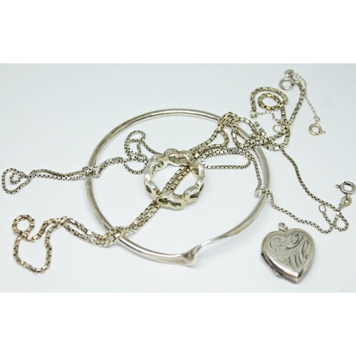 478 - A modernist hallmarked silver bangle, together with two silver chains, a ring formed as joined heart... 