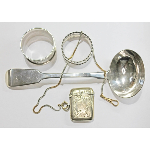 481 - A mixed lot of silver comprising a ladle and two serviette rings, together with a silver plated vest... 