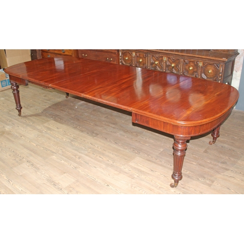 88A - A mahogany wind out table circa 1850, D ends, turned and fluted legs terminating on gilt brass and p... 