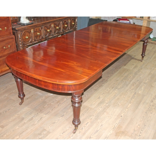 88A - A mahogany wind out table circa 1850, D ends, turned and fluted legs terminating on gilt brass and p... 