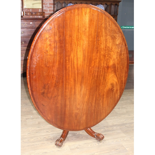 88C - A 19th century mahogany loo table of oval form with turned pedestal base with four legs having scrol... 
