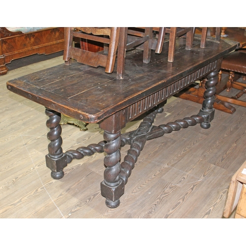 88I - A 17th century and later oak refectory table, three plank top with cleated ends, carved frieze, twis... 
