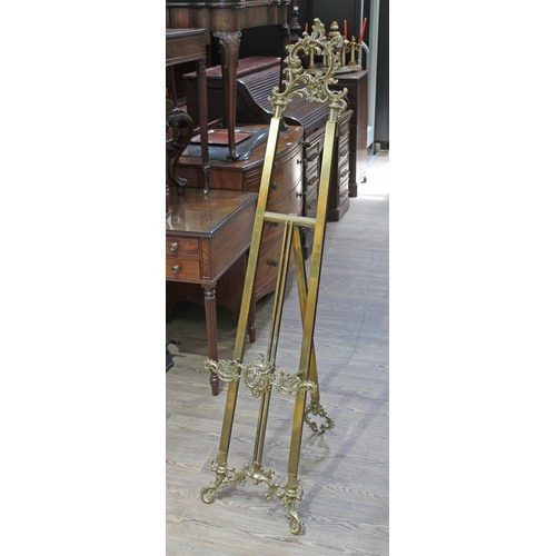 88S - A late 19th century brass easel, numbered S897, height 193cm.