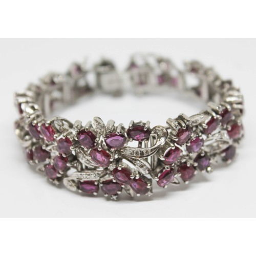 100A - A continental white metal ruby and diamond cocktail bracelet, length 16.5cm, gross wt. 47.29g.