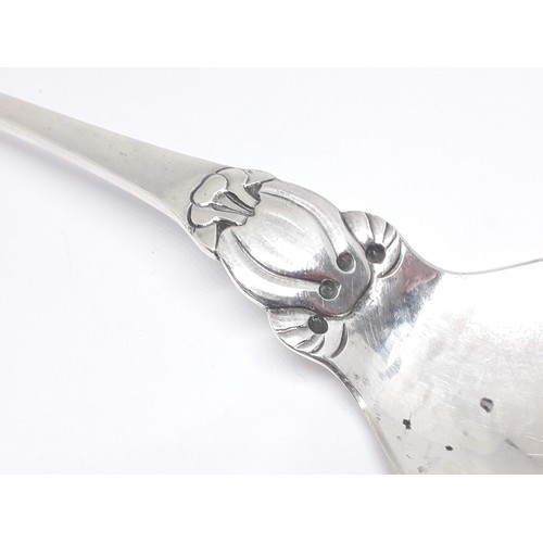 321 - A Georg Jensen Sterling silver spoon number 49, scroll finial and hammered bowl, length 18.5cm.