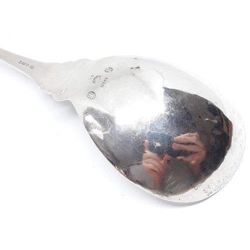 321 - A Georg Jensen Sterling silver spoon number 49, scroll finial and hammered bowl, length 18.5cm.