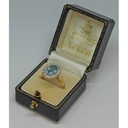 101 - An aquamarine and diamond cluster ring, the oval brilliant cut central stone measuring approx. 8mm x... 