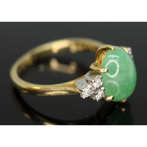 103 - A diamond and jade cabochon ring, the central jadeite jade cabochon measuring approx. 9mm x 8mm x 4m... 