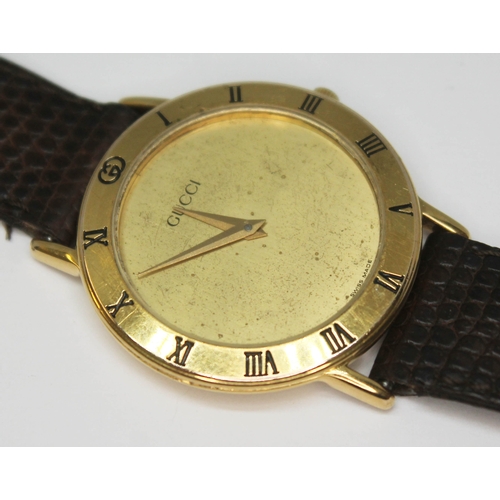 112 - A gold plated Gucci dress watch ref. 3000.2.M with plain gold tone signed dial and Dauphine hands, t... 