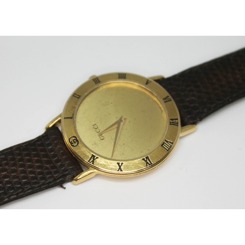 112 - A gold plated Gucci dress watch ref. 3000.2.M with plain gold tone signed dial and Dauphine hands, t... 