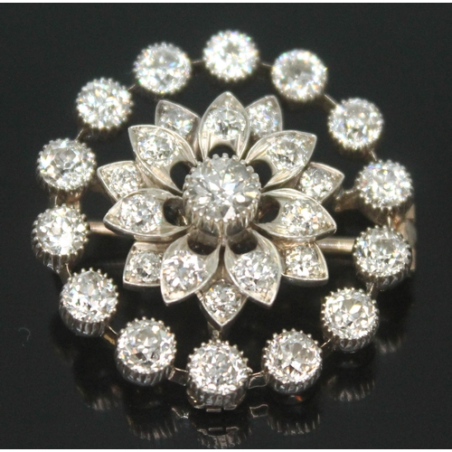 167 - An Art Deco diamond cluster brooch, the old cut central stone weighing approx. 0.25 carats, surround... 