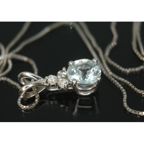 169 - An Italian diamond and aquamarine pendant, the round brilliant cut aquamarine diam. approx. 6mm and ... 