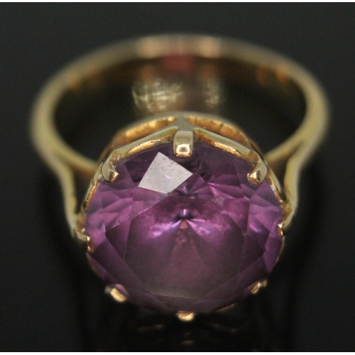 200 - An amethyst ring, the stone diam. 12mm and depth 6mm, band unmarked, gross wt. 5g, size N.