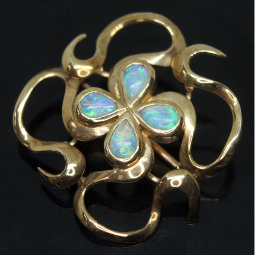 226 - A modern Arts & Crafts style hallmarked 9ct gold brooch set with four pear shaped precious opal cabo... 