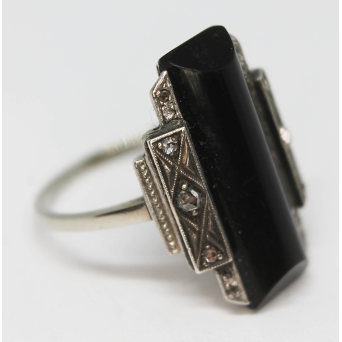 100 - An Art Deco diamond and black onyx ring, band unmarked, gross wt. 5.20g, size P.