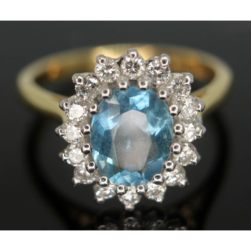 101 - An aquamarine and diamond cluster ring, the oval brilliant cut central stone measuring approx. 8mm x... 