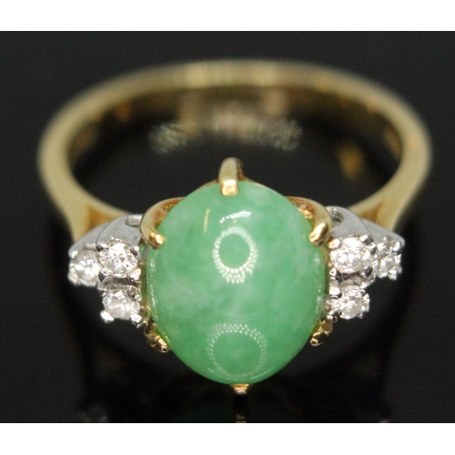 103 - A diamond and jade cabochon ring, the central jadeite jade cabochon measuring approx. 9mm x 8mm x 4m... 