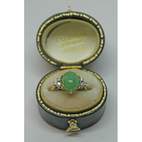 103 - A diamond and jade cabochon ring, the central jadeite jade cabochon measuring approx. 9mm x 8mm x 4m... 