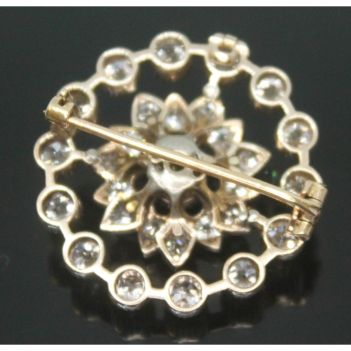 167 - An Art Deco diamond cluster brooch, the old cut central stone weighing approx. 0.25 carats, surround... 